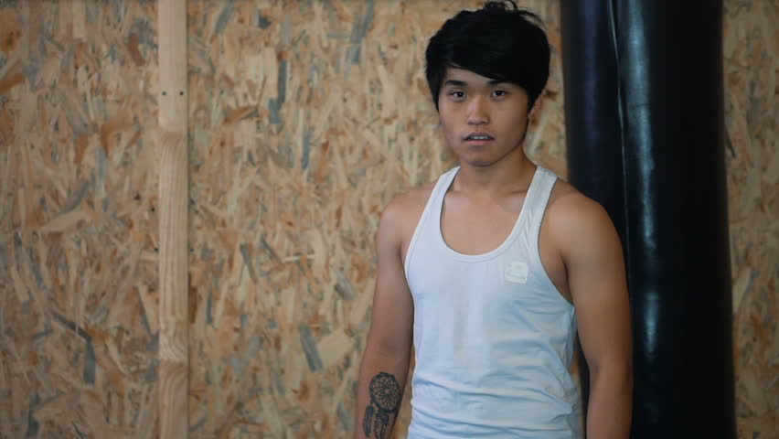 Young man beside punching bag