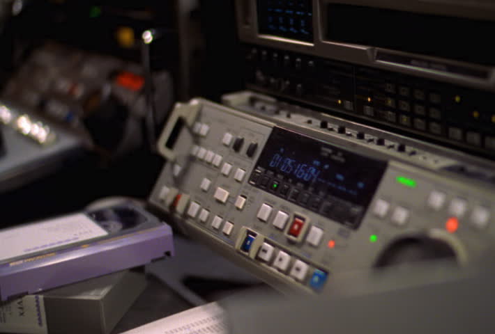 Closeup of woman's hand inserting tape in pro VCR