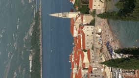 Vertical video: Amazing Budva Old town beach time lapse. Montenegro, Adriatic sea, Establishing Shot, Long shot, Vertical shot.