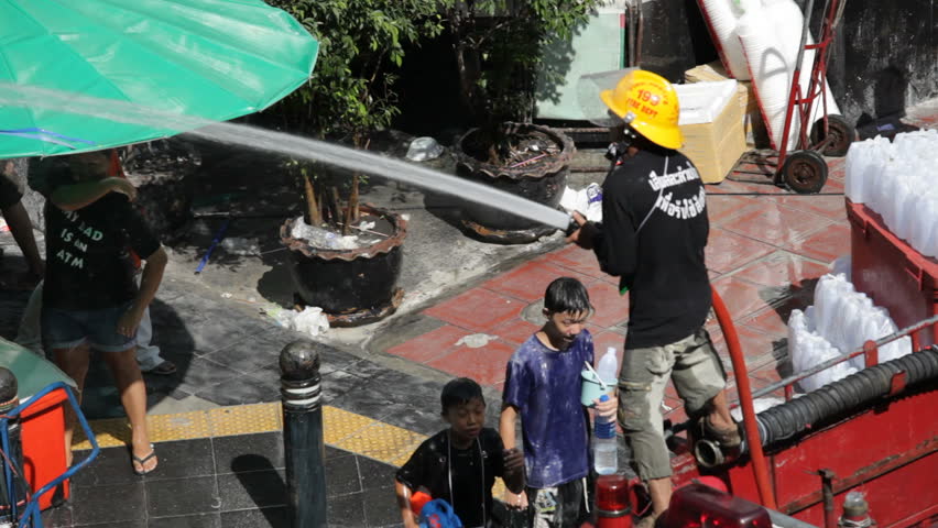 BANGKOK - APRIL 14: A firefighter is celebrating Songkran Water Festival on