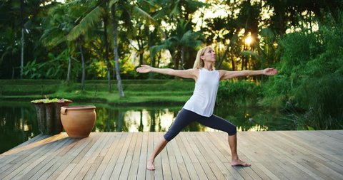 Woman practicing yoga outdoors, health and wellness concept