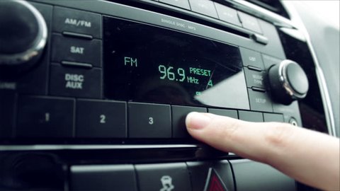 Fingers adjusting luxury car dial between two radio stations

Dash is a Chrysler 200, 2011
December 2016