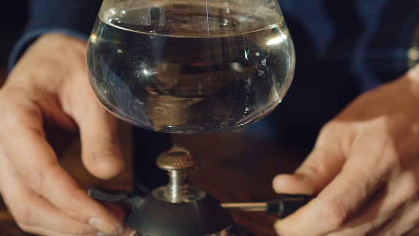 Close up of preparing coffee in alternative vacuum coffee maker. Slowly