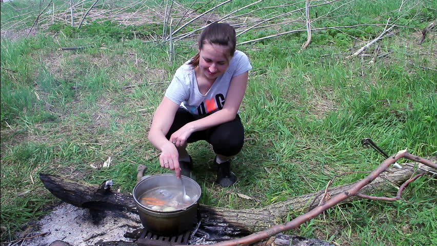 pot with fish soup, fish soup on fire outside