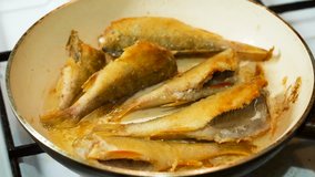 Fish fried in hot oil in a frying pan