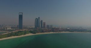 Panning past Emirates Palace over the water from above