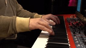 Pianist playing on electric piano. Slow motion view.