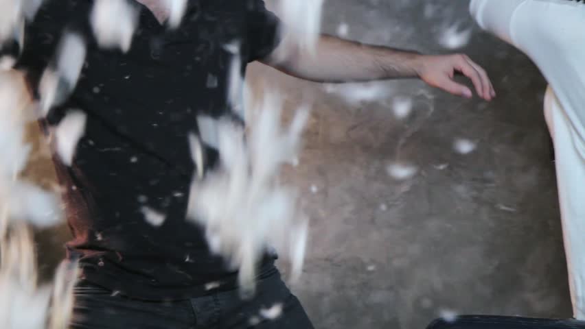 Feather party. Winter feather party. Christmas fight with pillows. Boy and girl with feather and pillows. New Year 