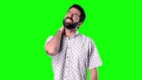 Man with beard with neck pain on green screen chroma key