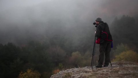 Russia, The Demirji Yayla, Crimea - 17 October 2012: A photographer adjusts the angle and snap the photo of the forest. Editorial Stock Video