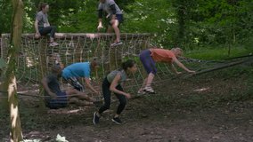 4K Competitors in assault course race, woman pauses for breath in foreground (UK-Oct 2016) - Powered by Shutterstock - Get 15% off with code: PIKWIZARD15