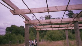 4K Competitors climbing monkey bars on assault course, 1 girl struggles (UK-Oct 2016) - Powered by Shutterstock - Get 15% off with code: PIKWIZARD15