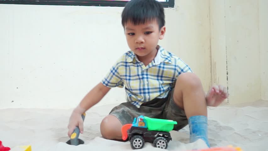 Asian boy is playing with educational toy in sandbox Royalty-Free Stock Footage #21977983