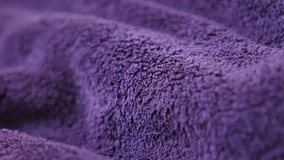 Violet polar blanket synthetic fibers and  texture panning 4K 2160p 30fps UltraHD  footage - High quality warming fleece purple polyester fabric material slow pan 3840X2160 UHD video