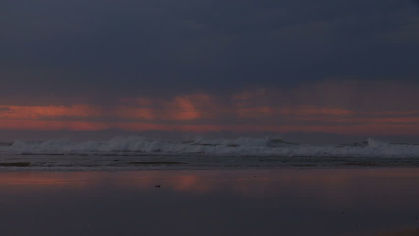 Early morning rain over beach sunrise