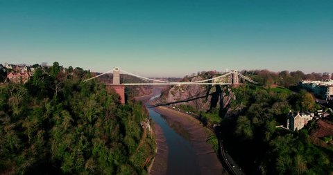 Aerial shot of Isambard Kingdom Brunel's iconic Bristol Clifton Suspension Bridge. Beautiful smooth drone shot of the Avon Gorge and the suspension bridge filmed on a sunny day in December. 