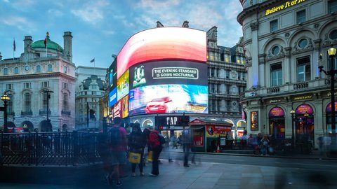 London, England. Circa 2016. Hyperlapse of the crowded Piccadilly Circus in London's West End, City of Westminster. The Circus is known for its video display and neon signs. From day to night.