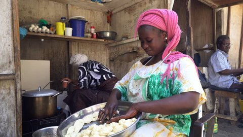 African woman knead dough in the market - 2016 April: Dakar, Senegal
