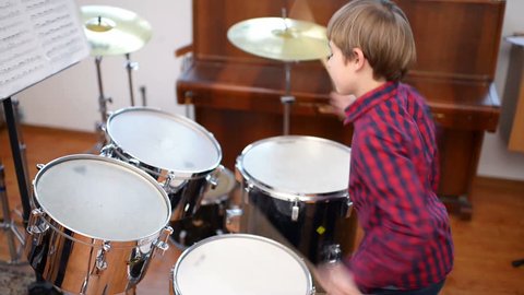 Kid studying drums at school