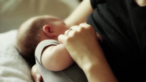 A beautiful newborn baby breastfeeding