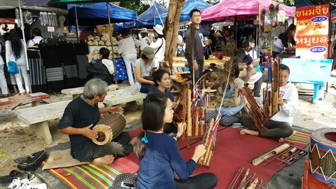 CHIANG RAI, THAILAND - DECEMBER 3 : 4K Unidentified asian group playing angklung happily in Wat Rong Sua Ten temple on December 3, 2016 in Chiang rai, Thailand