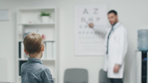 Young Boy is Checking His Eyesight in a Doctor's Office. room on a Boy. Shot on RED Cinema Camera in 4K (UHD).