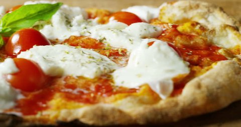 high quality pizza typical Italian food with Italian mozzarella cheese and fresh tomato sauce freshly harvested, with a fragrant basil leaf.Concept of: italian food, italy, restaurants and tradition.