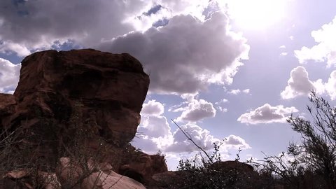 Time lapse film footage of dramatic clouds against a desert mountain landscape