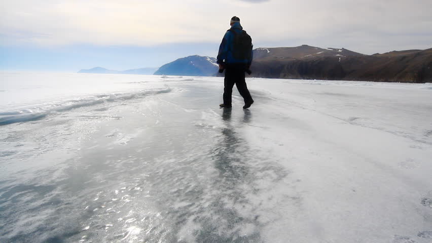 man is going on the ice lake