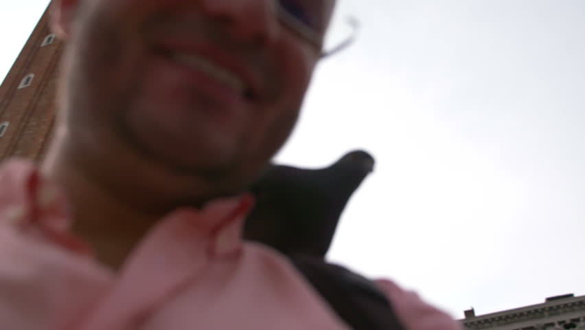 Man feeding pigeons on St. Mark