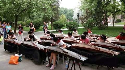 Beijing,China-Oct 2,2016: Girls play Guzheng in the park for the show.
