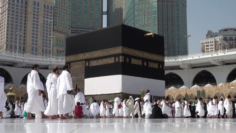 Mecca, Saudi Arabia - September 10, 2016: Muslim pilgrims put on their white ihrams circling around the holy Kaaba at daytime during Hajj in Saudi Arabia