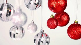 Silver and red Christmas background. Close up of New Year decorations isolated on white wall. Real time full hd video footage.