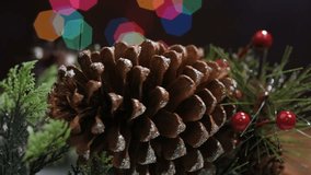 Christmas pine cones and other decorations with Christmas bokeh lights in the background while rotating.  - Powered by Shutterstock - Get 15% off with code: PIKWIZARD15