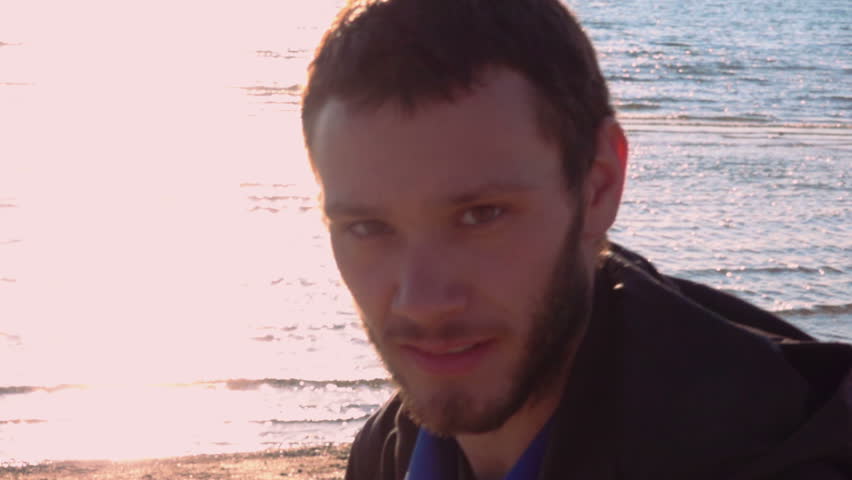 Boy Smile at Camera while Walking. Slow Motion, Beach, Sea Behind