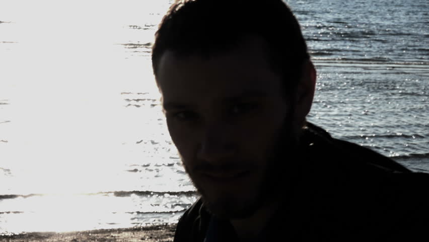 Boy Smile at Camera while Walking. Slow Motion, Beach, Sea Behind