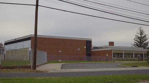 Day school exterior establishing 4k video shot. DX elementary high education building street view lock down. Matching ID 1026529736