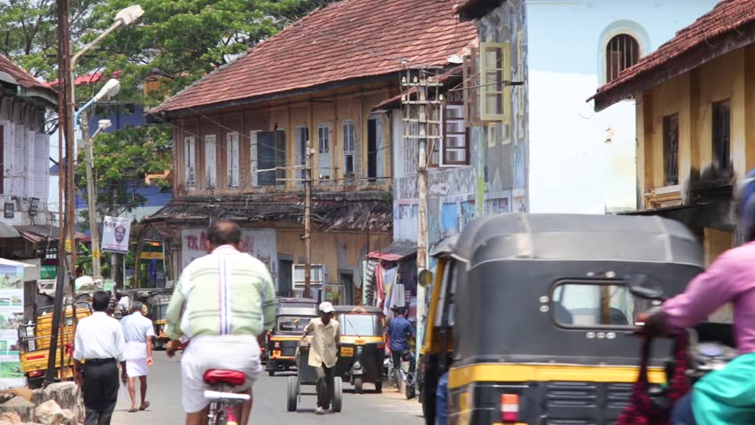 Cars and people on a busy street in India