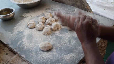 Indian food and sweets cooking, preparation, serving at a Dhaba- a traditional highway restaurant in India and South-East Asian sub-continent, mostly in non-urban areas 
    Video Stok