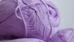 Slow tilt on pink yarn of wool wrapped in loose twist 4K 2160p 30fps UltraHD footage - Skeins of knitting wool shallow DOF close-up 3840X2160 UHD tilting video