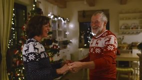 Senior couple dancing at Christmas tree in the evening - Powered by Shutterstock - Get 15% off with code: PIKWIZARD15