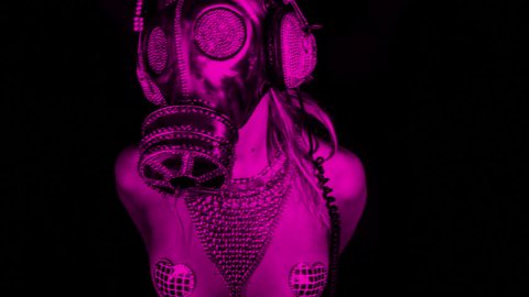 sexy woman dances with a gas mask covered in sparkling crystals. this is a special handmade item from our studio. how to survive the apocalypse in bling bling style