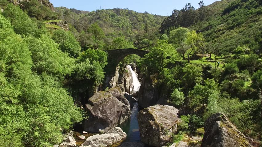 Tourists Crossing the Enchanted Valley (National Park of Geres, Portugal)
