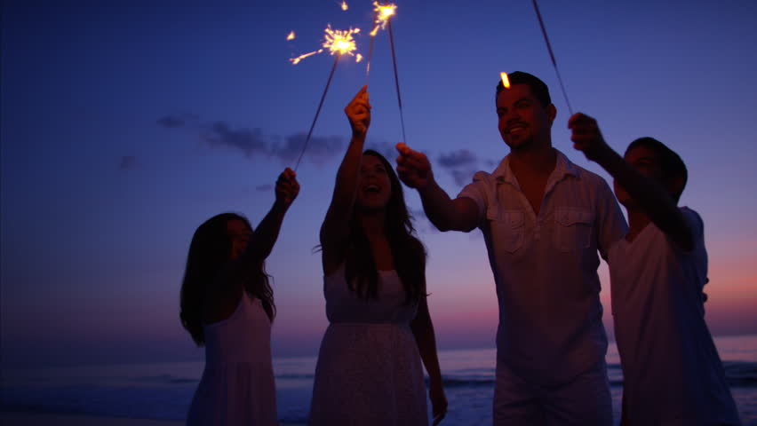 Silhouette carefree Hispanic parents kids together celebrate sparklers party birthday ocean beach sunset dusk RED DRAGON | Shutterstock HD Video #22098259