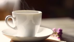 Aromatic steam from a of coffee over a white cup