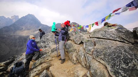 DINGBOCHE, NEPAL - APRIL 27, 2016: Group of tourists ascended at 5080 m elevation for acclimatization. After they'll stay overnight at 4400m elevation.
