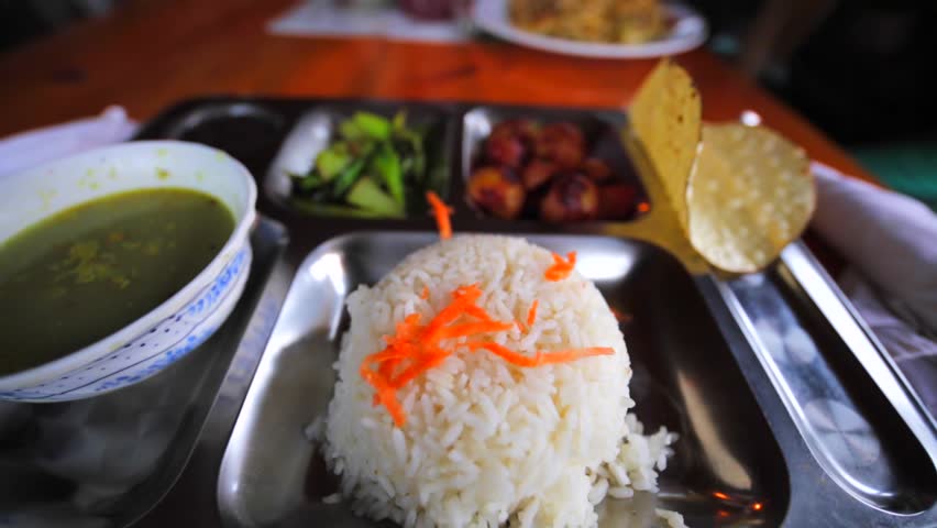Dal Bhat, a traditional nepalese meal that consists of steamed rice and a cooked lentil soup called dal. And hot garlic soup. Dingboche region in the Himalayas, Nepal