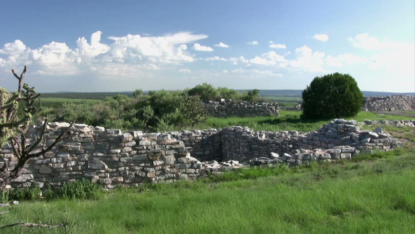 A raven flying through in the background at Gran Quivira Ruins at Salinas Pueblo Missions National Monument in New Mexico.