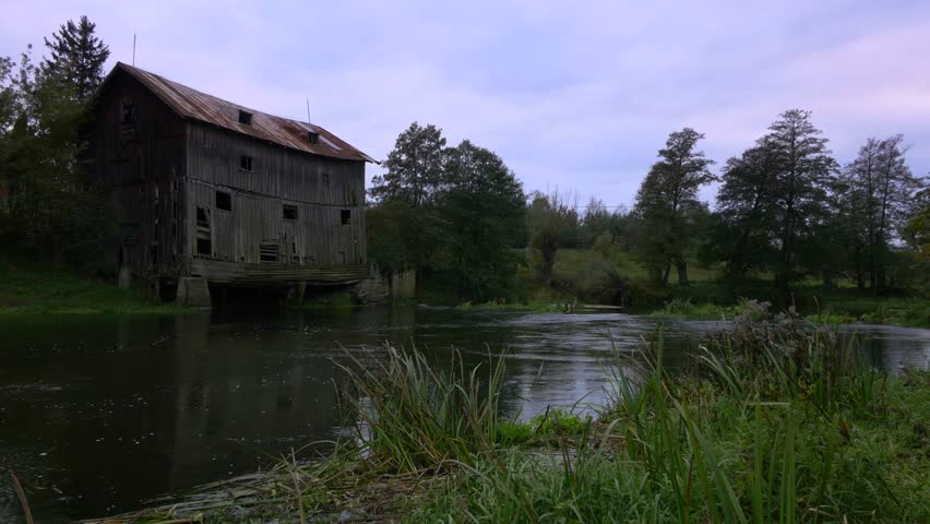 Old haunted house at river bank.