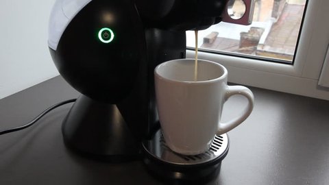 Closeview of Modern Coffee Machine that is making a fresh coffee in the morning